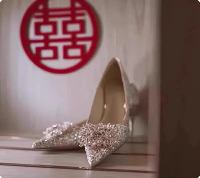 Champagne Xiuhe wedding shoes with rhinestones, pointed toe, fine heel, and one foot kick closure.