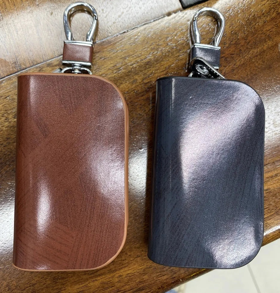 Genuine leather car key case with zipper closure and frosted finish in black or brown