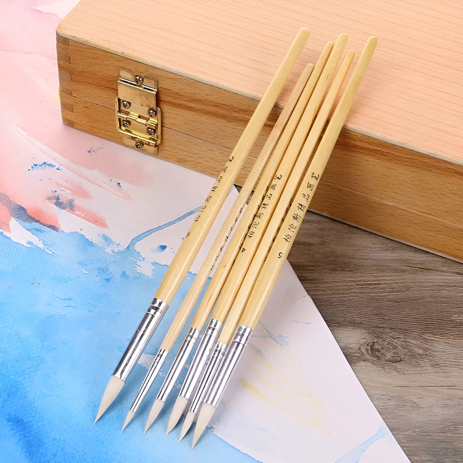 Six wooden-handled pointed wool line pen brushes arranged together.