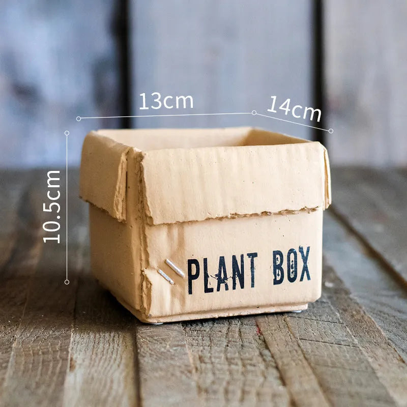 Cement flowerpot with brown paper box design and drainage holes for indoor planting