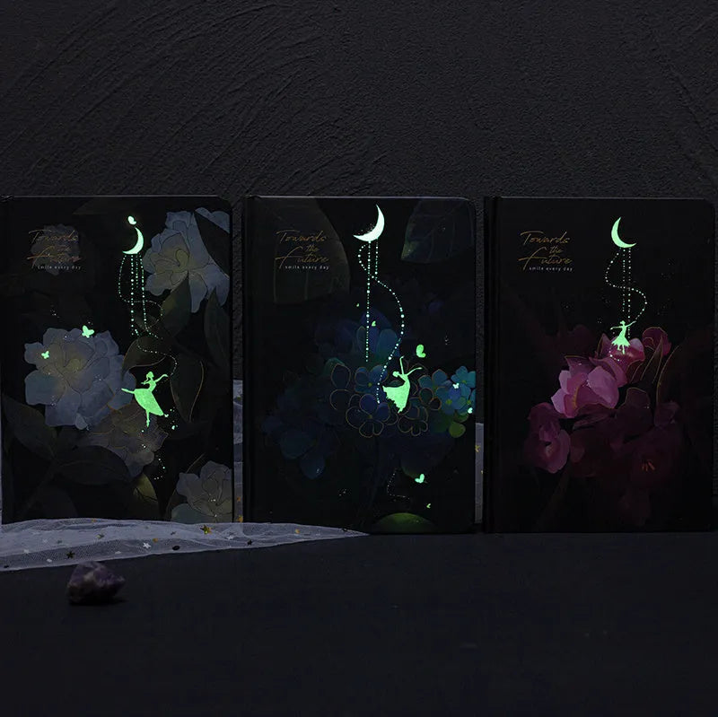 A5 notebook with luminous cover open to show pages with colour illustrations