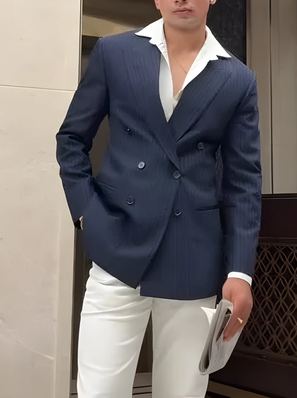Men's classic stripe double-breasted blazer on a hanger showing the front button closure and striped pattern.