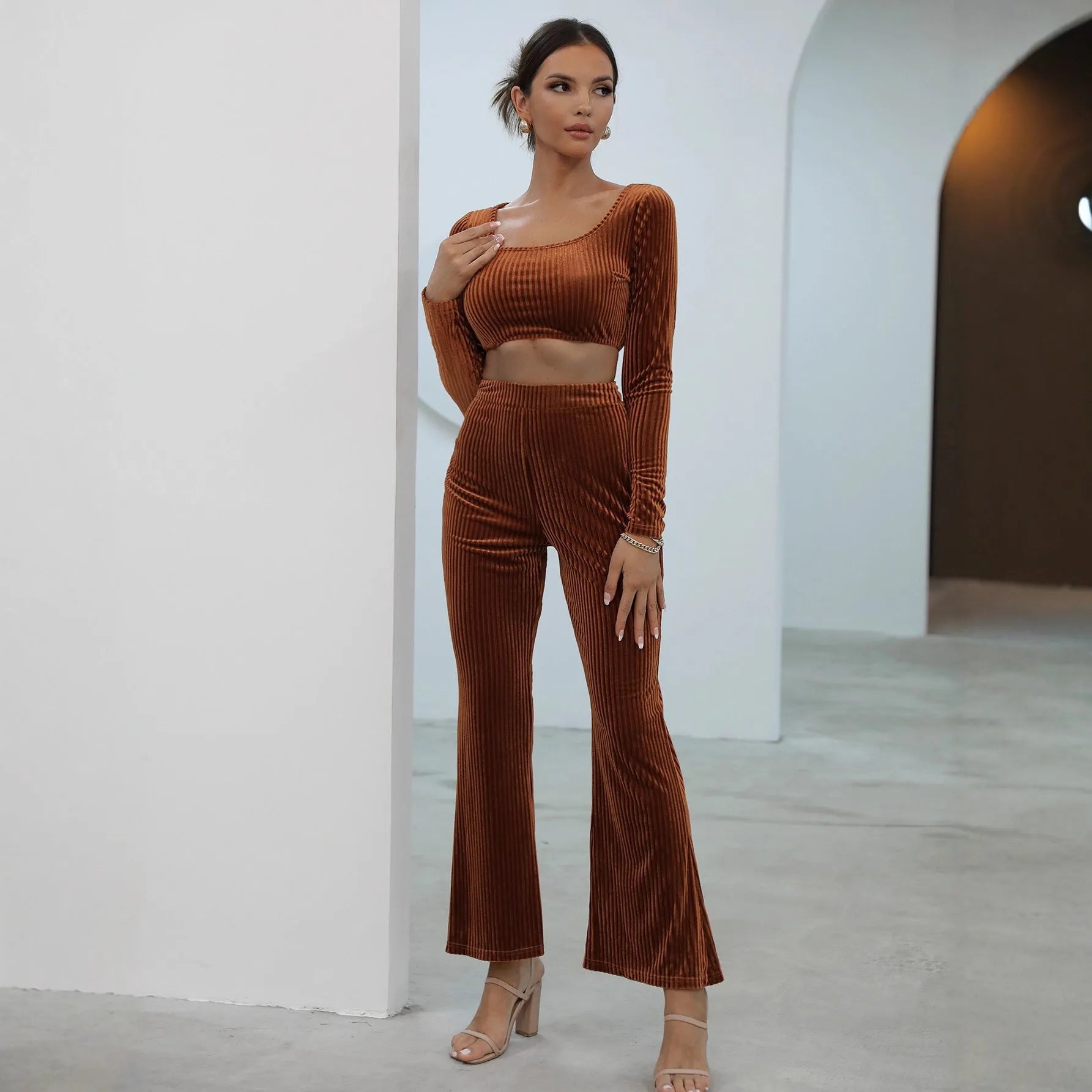Caramel coloured long sleeve sweater and trousers casual set on a hanger.