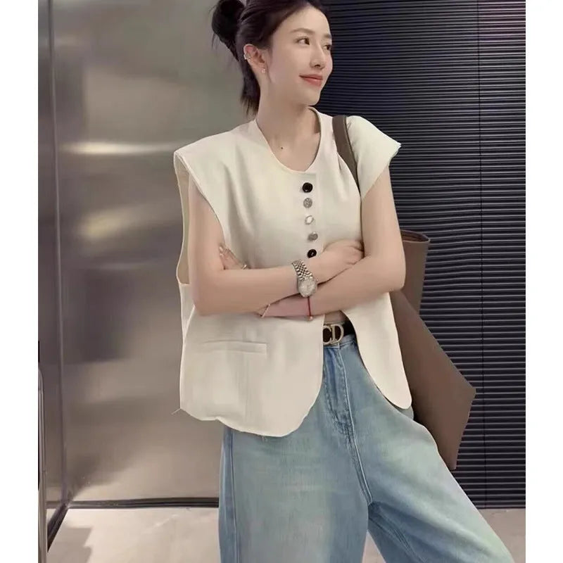 Women's loose fit polyester vest with pockets in milky white colour showing front view