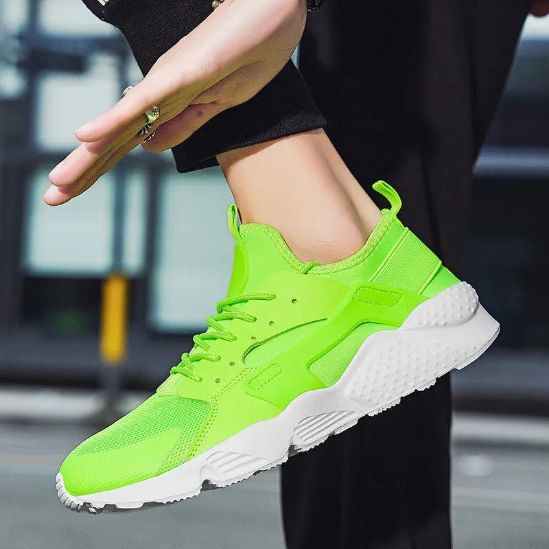Men's green low-top casual shoes with mesh upper and cross shoulder straps on a flat sole.