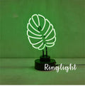 Minimalist bamboo-shaped desktop lamp with green light in white tube, showing large and small size options