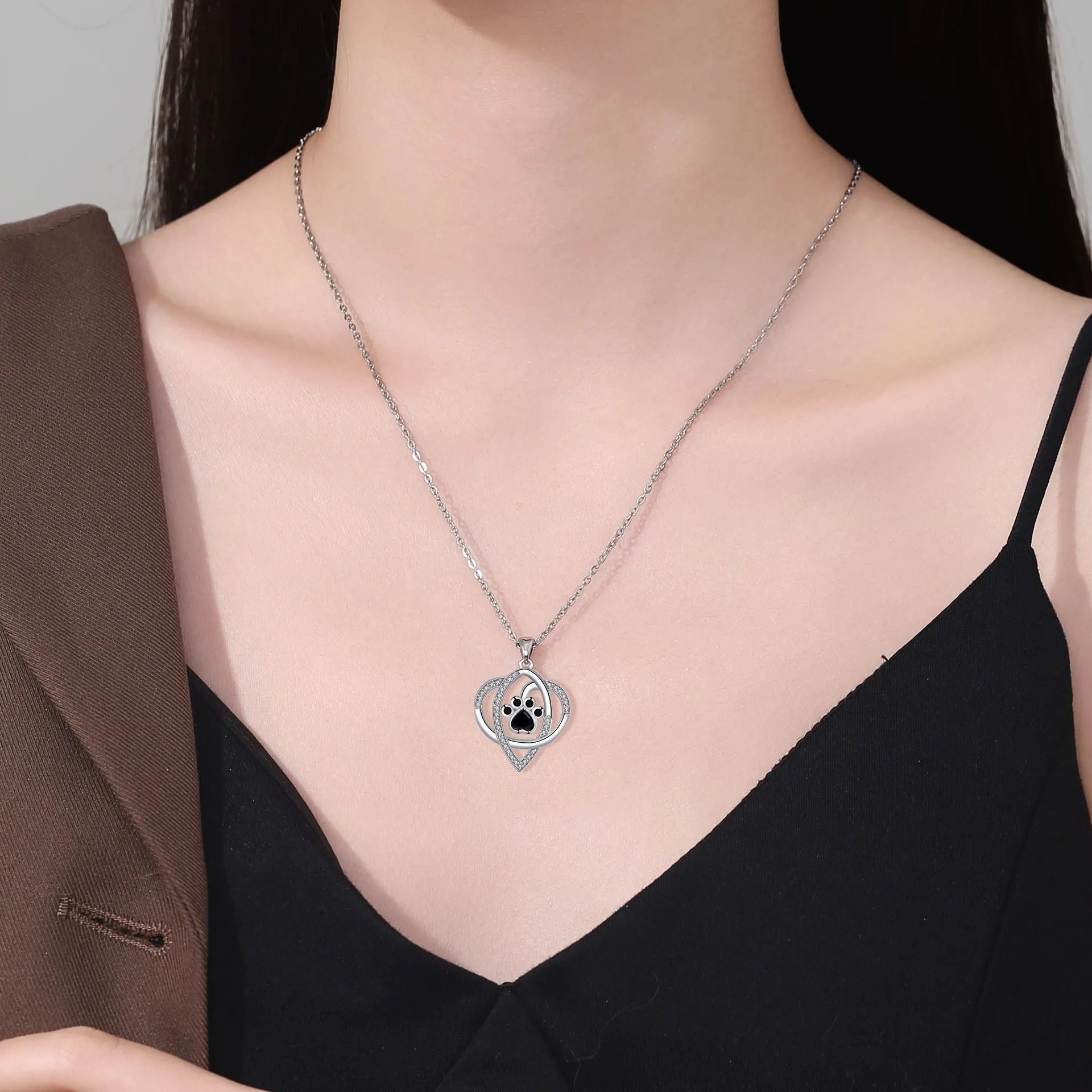 Copper necklace for women with a dog's paw print pendant on a cross chain.