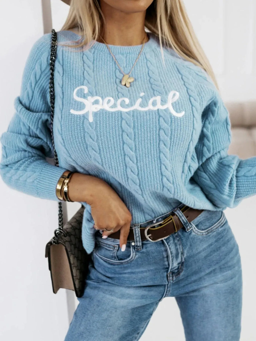 Blue crew neck pullover sweater with embroidered letters design on the chest.