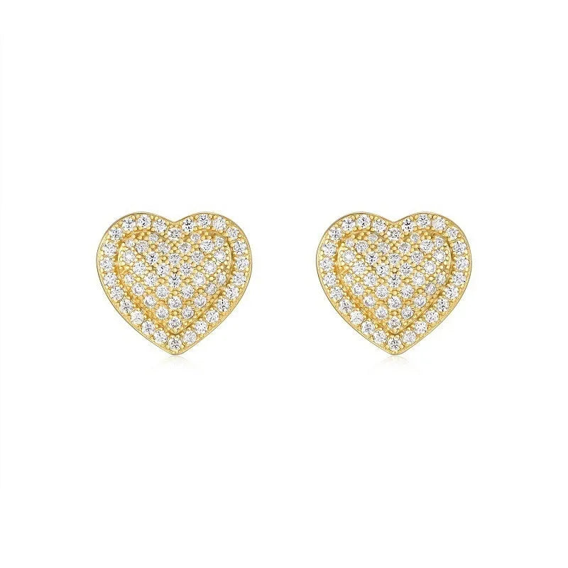 Golden heart-shaped stud earrings with moissanite centre on silver background