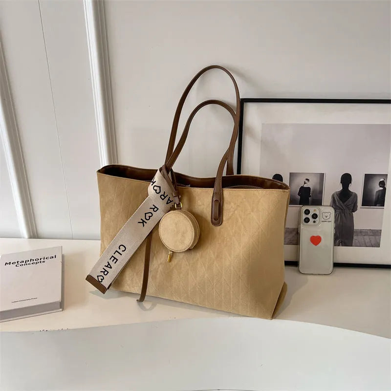 Large soft polyester shoulder bag in horizontal square shape with outer pocket, shown in light khaki colour.