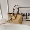 Large soft polyester shoulder bag in horizontal square shape with outer pocket, shown in light khaki colour.
