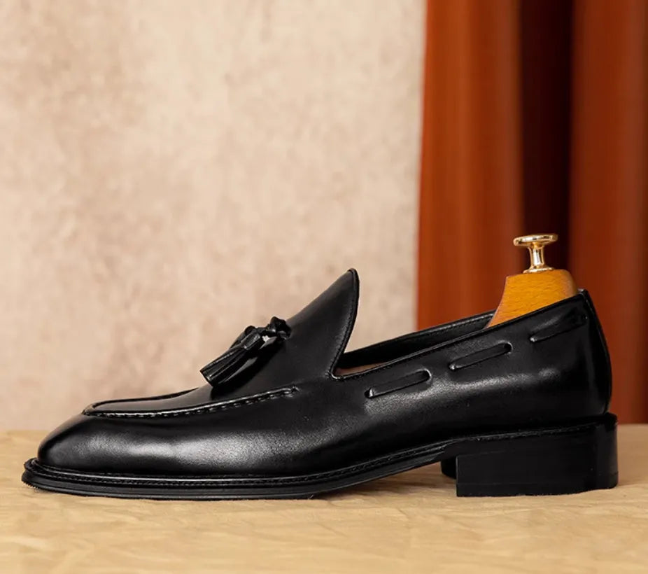 Men's black genuine leather loafers with fringe detailing and slip-on design