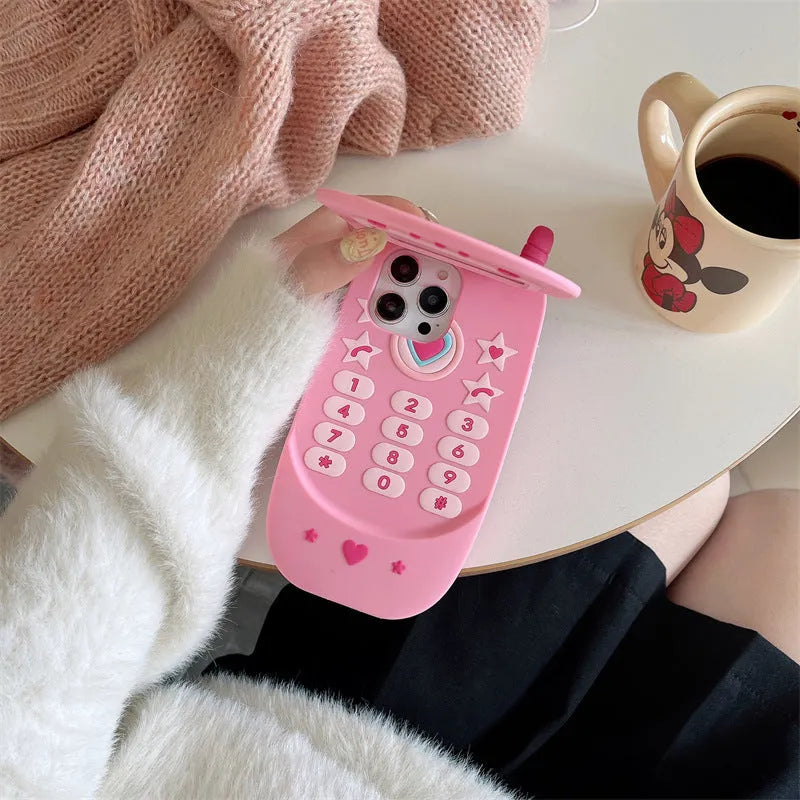 Light pink silicone flip phone shaped mirror case for iPhone on a white background.