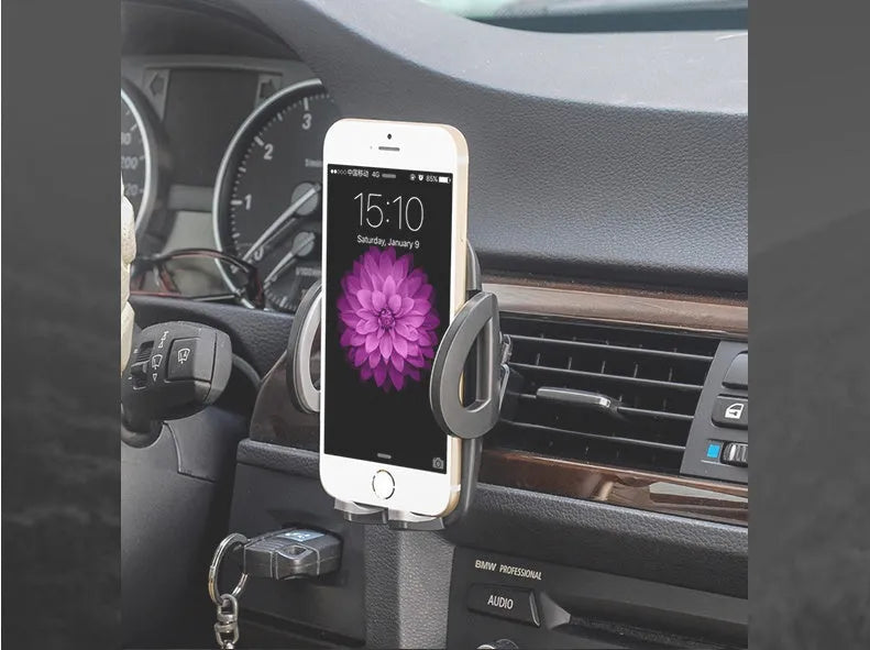 Black plastic car air vent mobile phone holder mounted on vehicle dashboard