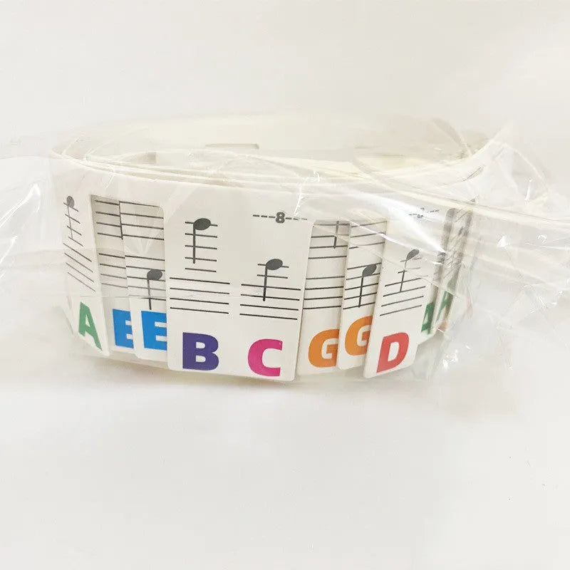 Set of 88 key piano keyboard stickers showing black note and colour note bar designs on white cardboard.