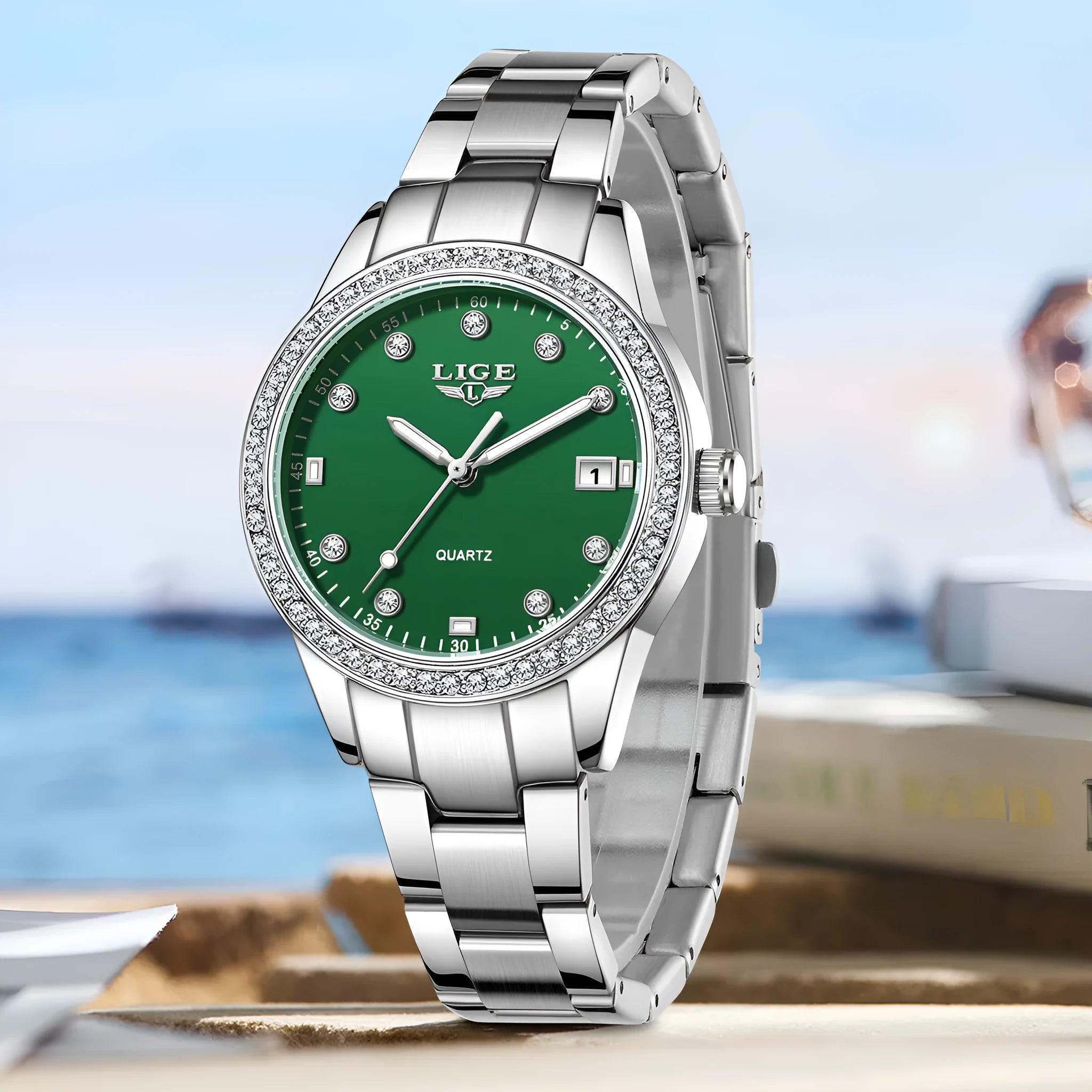 Silver stainless steel ladies watch with diamond bezel, luminous hands, and round 34mm dial.
