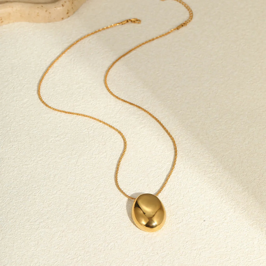 Gold-plated necklace with geometric pendant on stainless steel chain, showing 18K plating and adjustable length