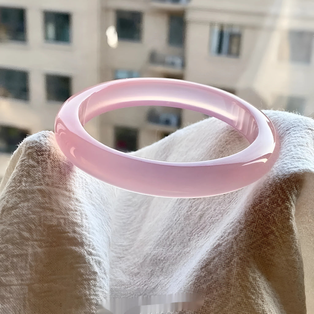 Natural agate wide tire bracelet in pink colour showing stone texture and 10mm bead size