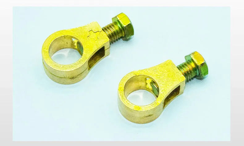 Solid copper car battery cable terminal clamp with brass bolts and a black plastic protective cover.
