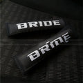 Pair of black car seatbelt shoulder pads made from cotton sponge cloth, showing embroidery detail.