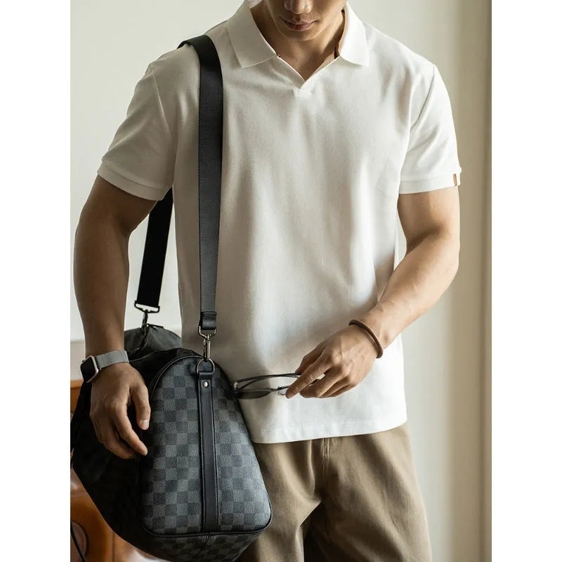 Men's short-sleeved blue polo shirt with a placket and collar, laid flat.