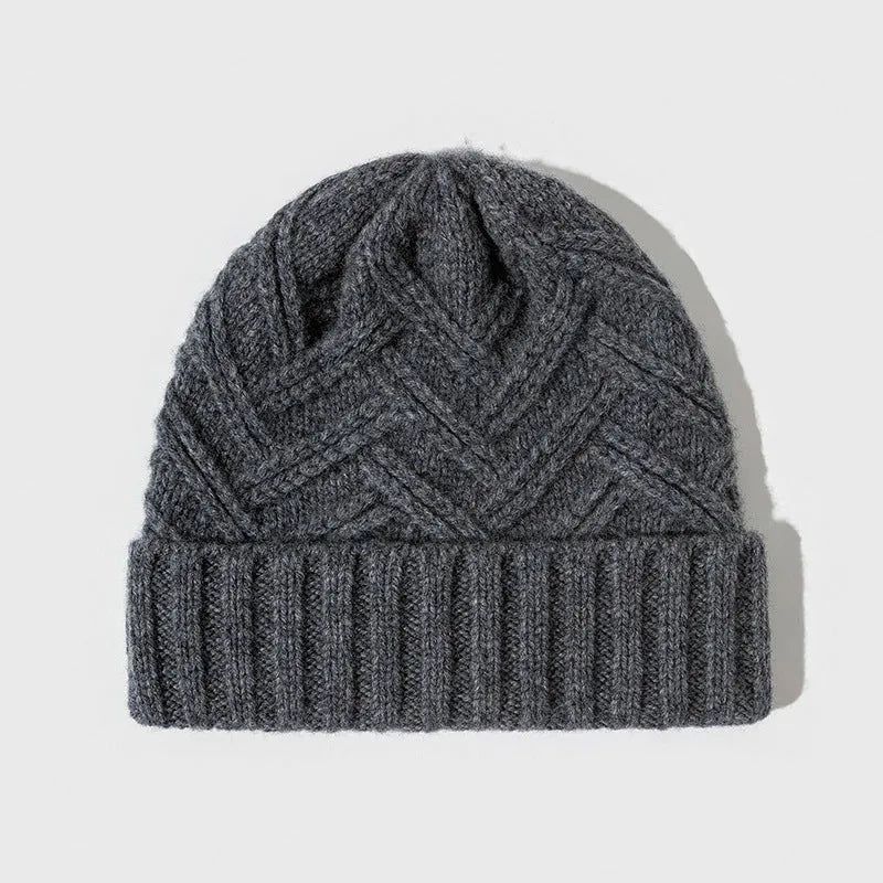 Women's wool knitted dome hat in various colours showing textured knit pattern and totem design elements