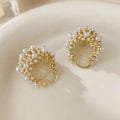Gold tone copper flower basket shaped earrings with small rice-shaped pearl inlay beads.
