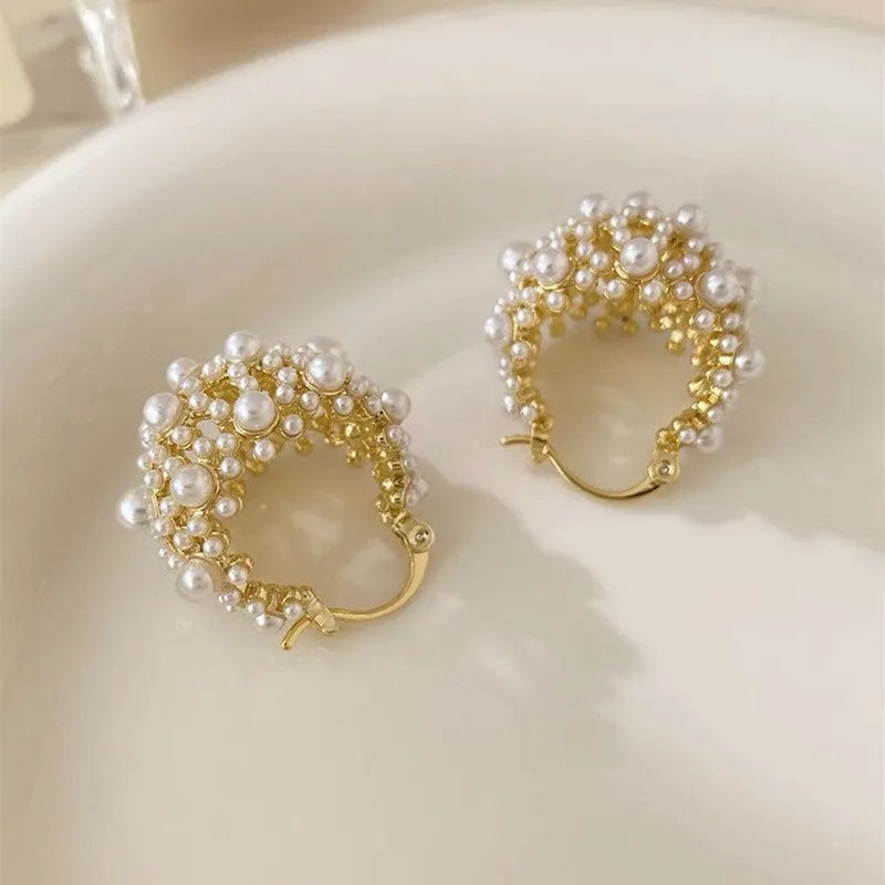 Gold tone copper flower basket shaped earrings with small rice-shaped pearl inlay beads.