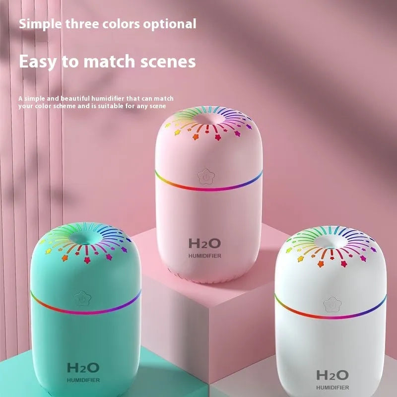Small white cube-shaped USB humidifier with water tank on a wooden desk.