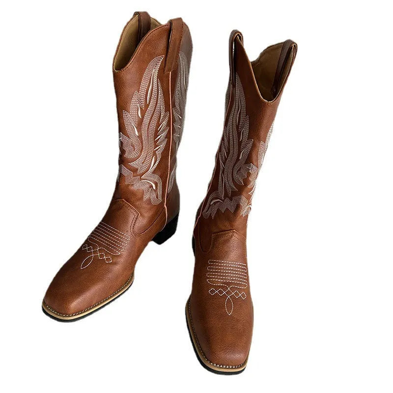 Brown women's mid-calf Martin boots with embroidered pattern, leather lining, and a lace-up front.
