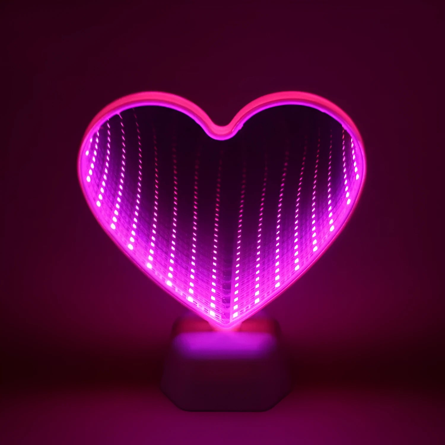 Rose red double-sided love tunnel shaped LED decorative light on a table