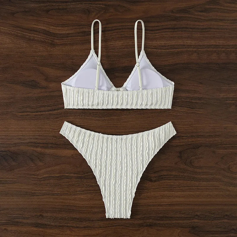 White women's V-neck bikini set with sleeveless top and shorts on a plain background.