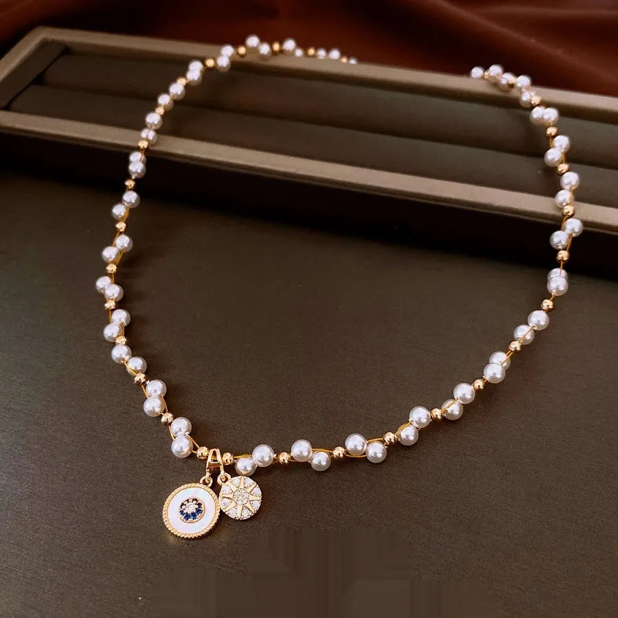 Gold electroplated pendant necklace with zircon stones and imitation pearl centre on clavicle chain