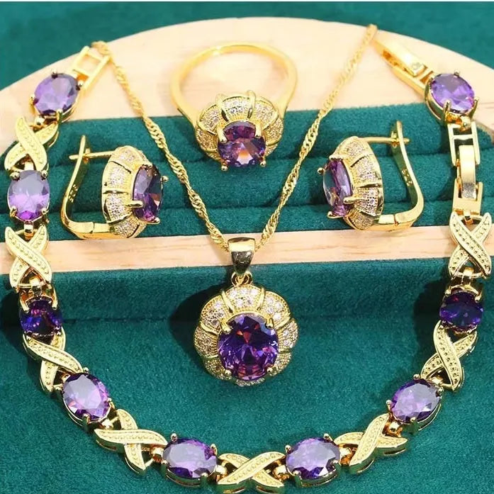 18k gold plated jewellery set with cubic zirconia stones, showing necklace, earrings, bracelet, and ring.