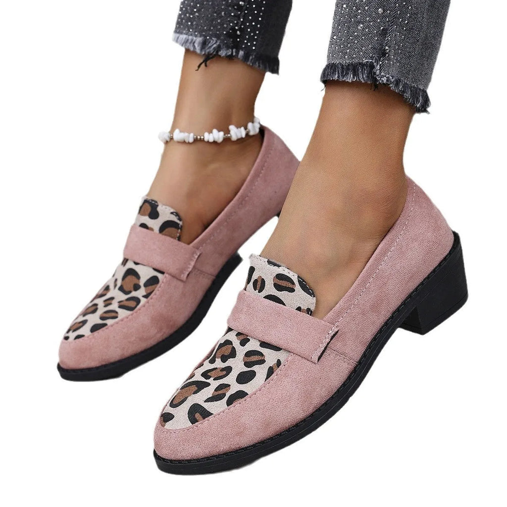 Women's leopard print suede slip-on shoe with a chunky mid heel and pointed toe on a brown background.