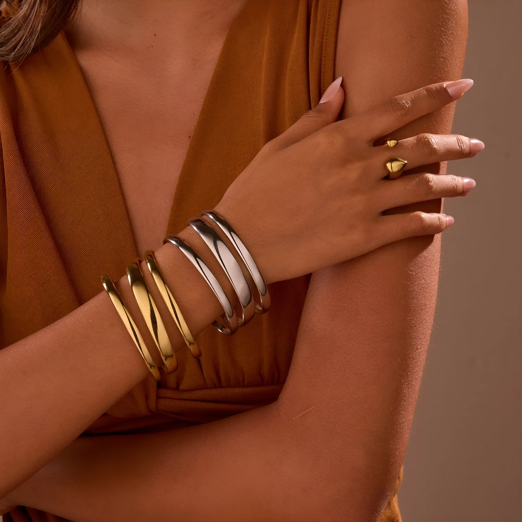 Stainless steel opening bracelet for women in gold or steel finish with geometric line design