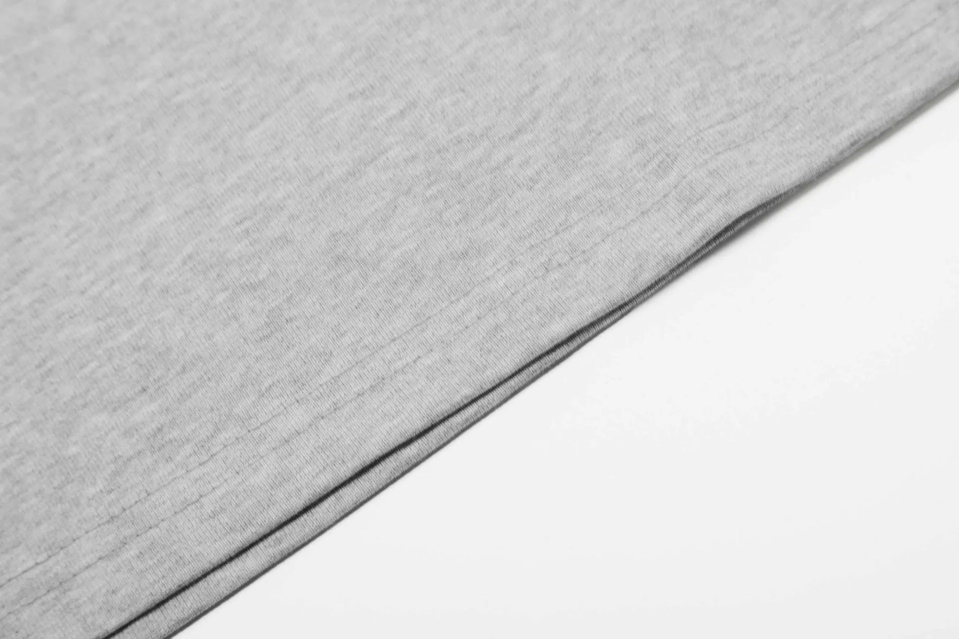 A loose-fitting long sleeve cotton pullover in grey, shown on a model for casual wear.