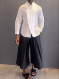 White asymmetric long sleeve shirt and black pleated pants set on model, regular fit, casual daily wear