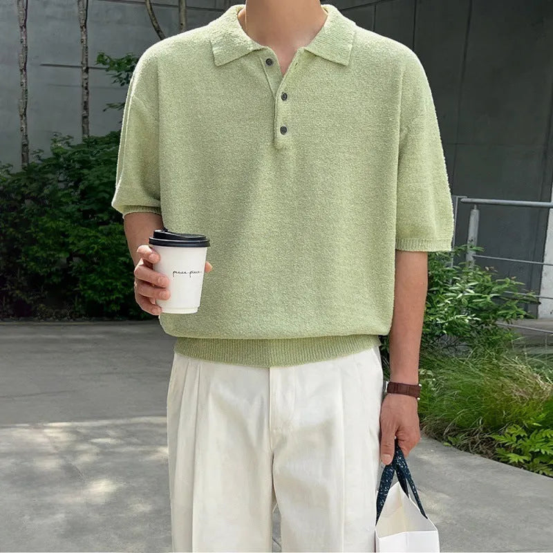 Man wearing a caramel coloured retro knitted polo shirt with short sleeves and an asymmetric design detail.