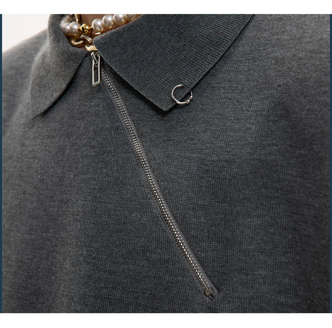 Man modelling a slim-fit black knitted polo shirt with an oblique diagonal zip closure and short sleeves.