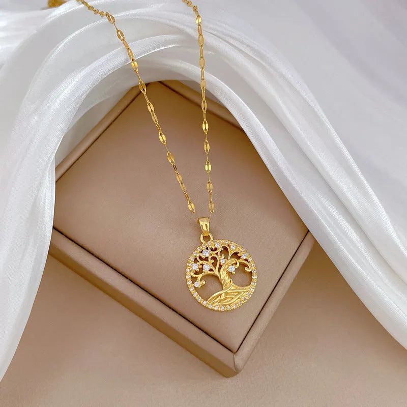 Gold-plated necklace with mother pearl pendant and rhinestone detailing on adjustable lip chain