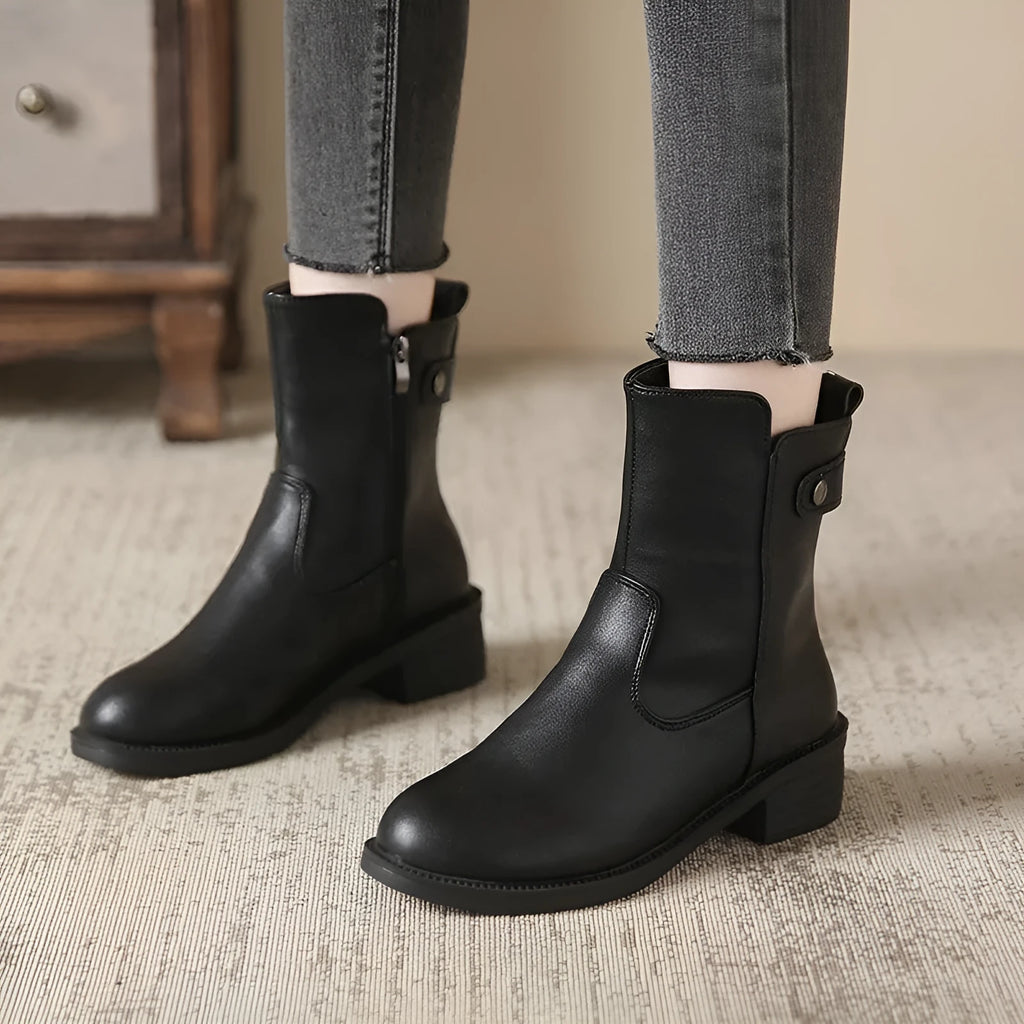 Black women's short boots with a side zip, round toe, and low rubber heel on a neutral background.