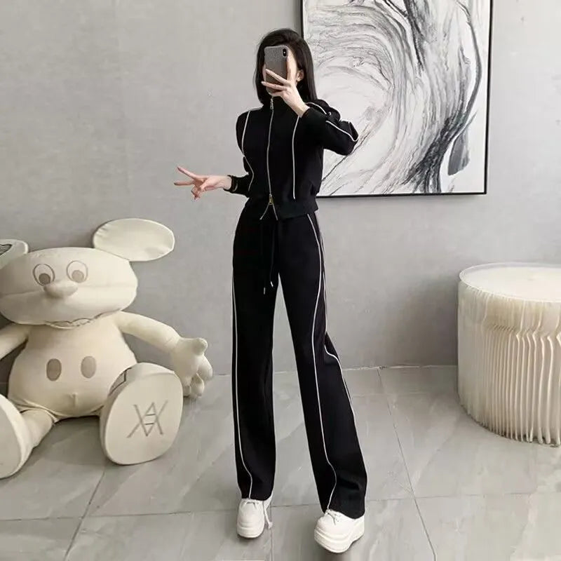 Women's two-piece set with short zipper sweater and wide leg trousers in solid colour polyester, black and white options available