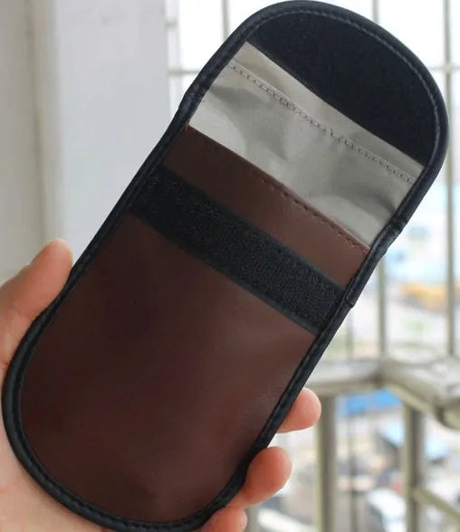Black microfiber faraday bag for blocking car key and phone signals, measuring 13.5 by 9.5 centimetres.