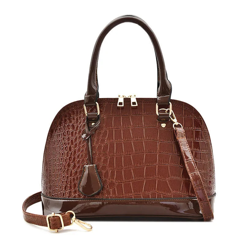 Large shiny black PU leather crossbody shoulder bag with shell shape on a white background