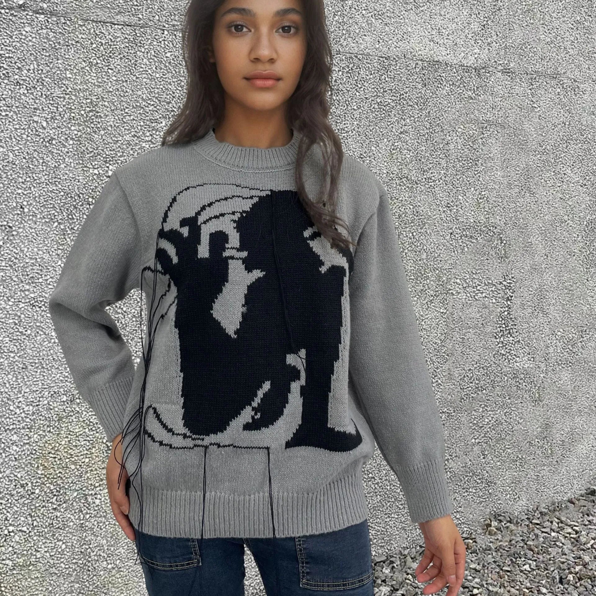 Women's loose alpaca wool tassel sweater in gray, round neck pullover style, side view on model