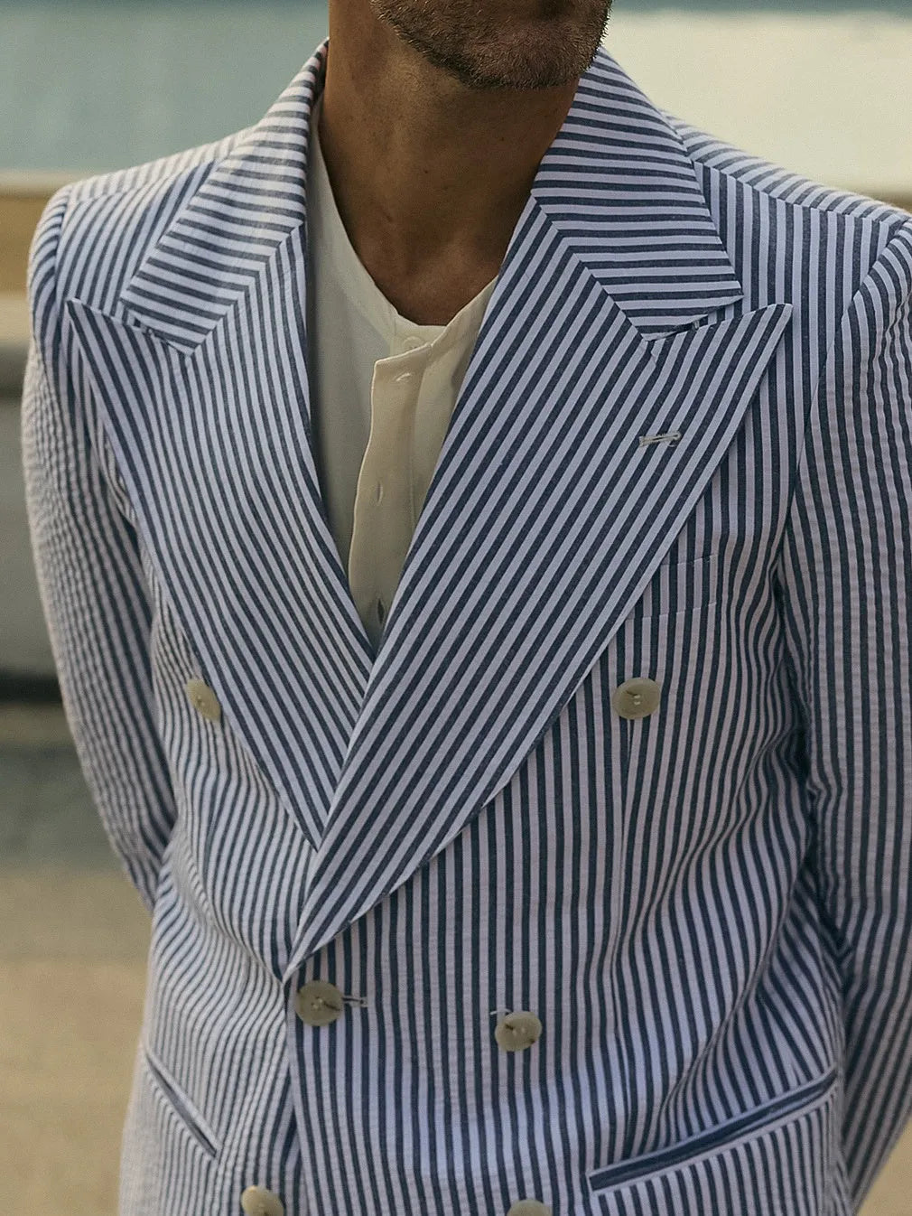 Women's blue and white striped polyester suit set with long-line blazer and matching trousers