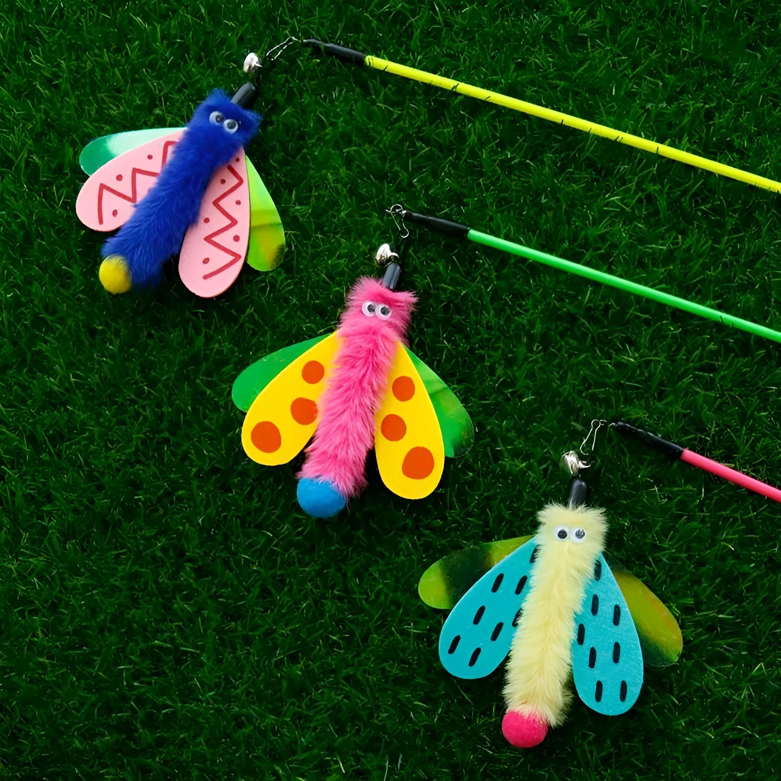 Cat wand toy with bell dragonfly attachment in green, yellow, and pink on white background