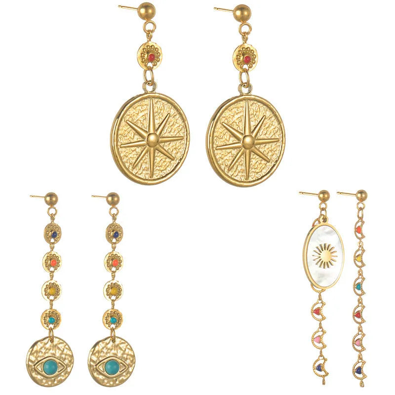 Three pairs of geometric stainless steel earrings on display: Eight Awn Star, Eye, and Shell Sun designs.