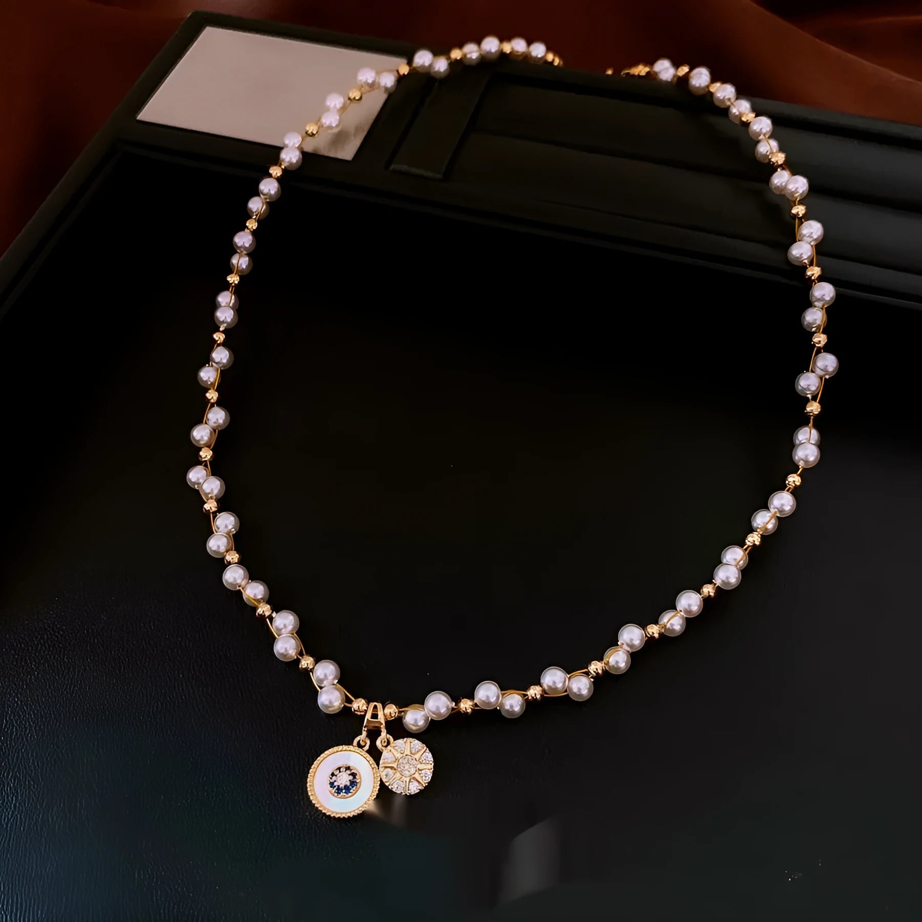 Gold electroplated pendant necklace with zircon stones and imitation pearl centre on clavicle chain